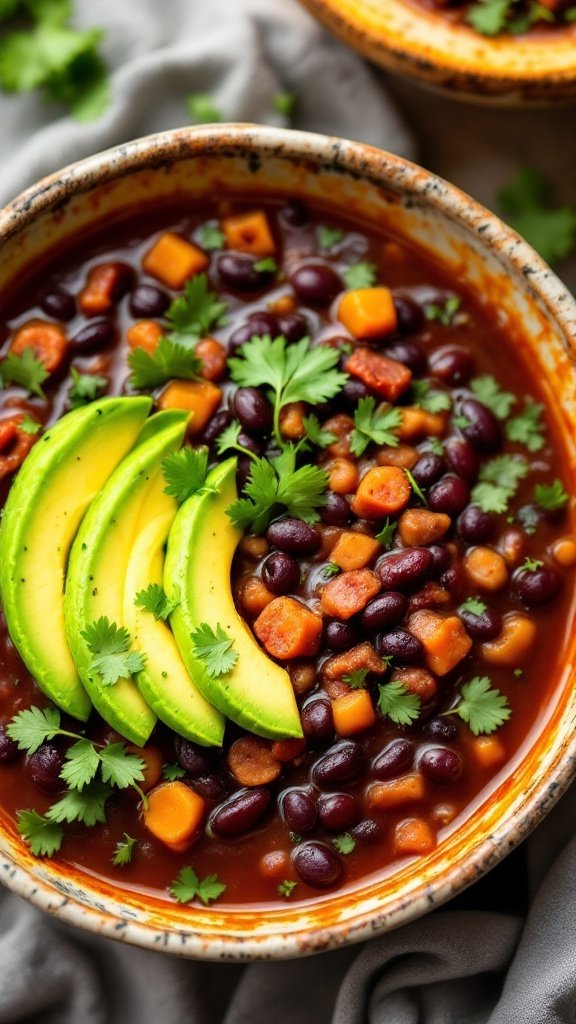 A bowl of spicy black bean and chorizo soup topped with avocado and cilantro.